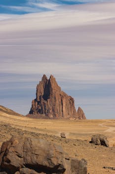 Stunning view of Shiprock, a towering rock formation in the arid New Mexico desert.