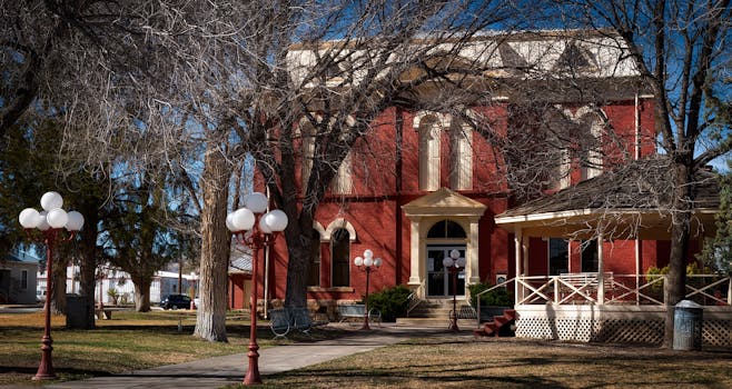 Charming red brick building with classic architecture set among trees in Brewster County, Texas.