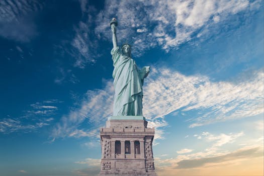 Iconic Statue of Liberty with a backdrop of a vibrant blue sky, symbolizing freedom and America.